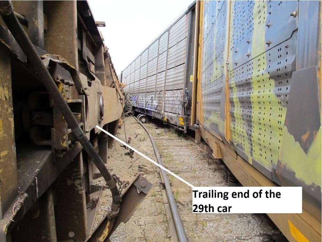 Looking from the trailing end of the 29th car as it came to rest about 2 feet from the inside rail of the curve. Note missing trucks (Source: Canadian National Railway Company)