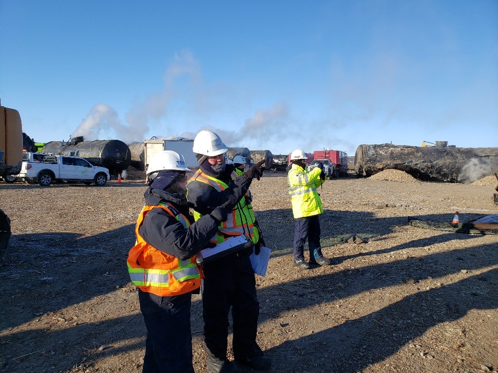 TSB personnel examining a tank car on site (Source TSB)