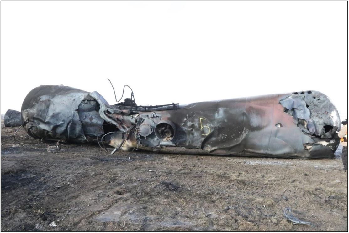 Severely damaged unidentifiable tank car with multiple breaches (Source: TSB)